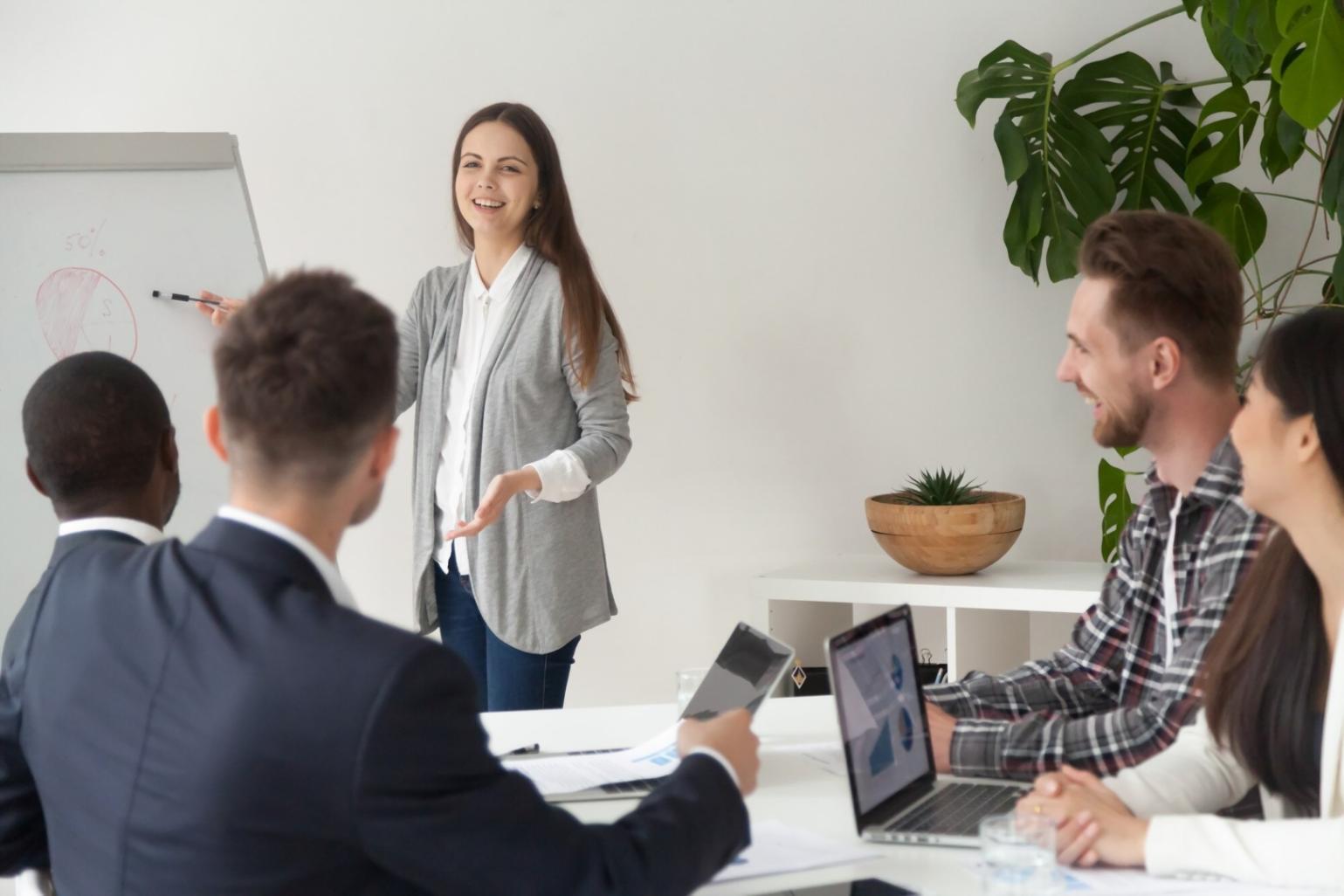 Professional reviewing budget documents with calculator and laptop